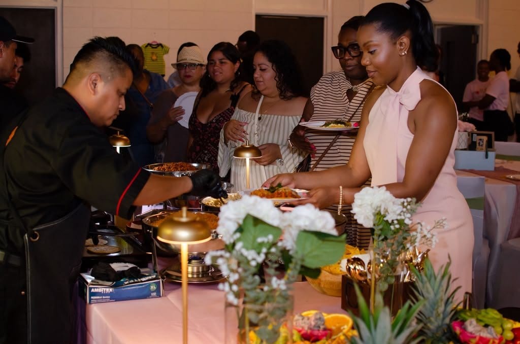 Cocina de Arte chefs serving guests at an indoor event