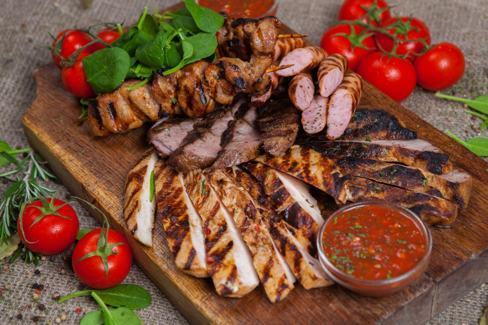 Grilled chicken on a wooden board with salsa